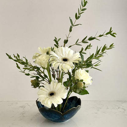 Dark blue ceramic vase with built in flower frog pin allowing for interesting floral bouquets