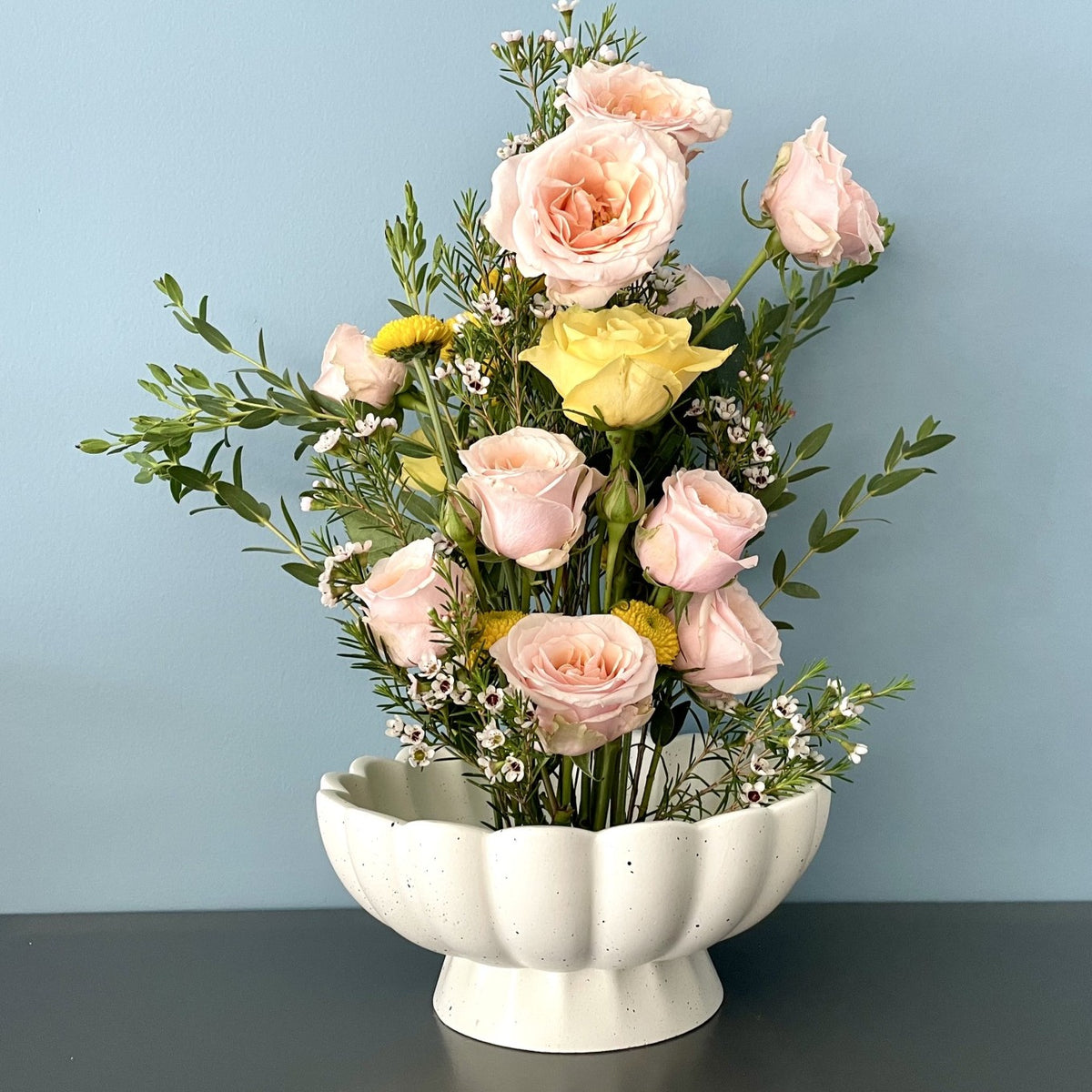 A 8" speckled ceramic vase with a built in flower frog pin allowing for an interesting  floral arrangement with fewer stems.   Looks great as a centerpiece, on a kitchen island or large table.   