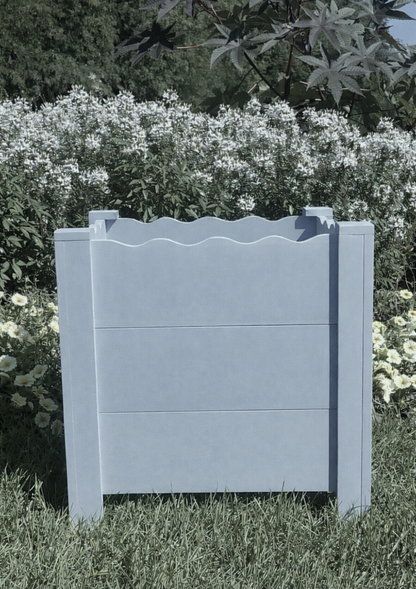 Handcrafted scalloped cedar planter box in Languid Blue, 19" square, shown in garden