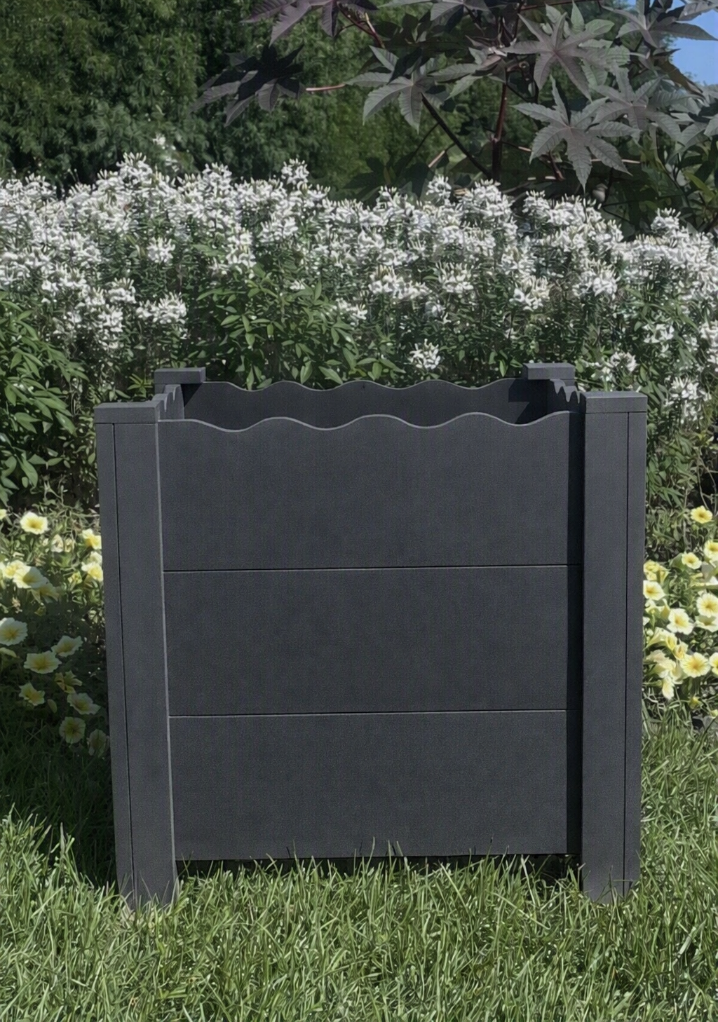 Handcrafted scalloped cedar planter box in Peppercorn gray, 19" square, shown in garden